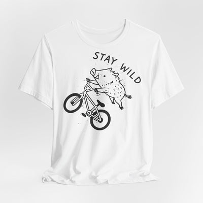 Nature Lover T-Shirt featuring a wild boar biking with the phrase 'Stay Wild' on a white unisex tee.